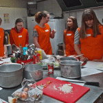 students from the local high school learning different cooking skills