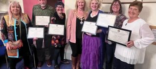 Representatives of our volunteer team receiving recognition alongside the Mayor of Teignmouth